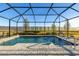 Enclosed pool and spa with lounge chairs at 939 Braewood Dr, Clermont, FL 34715