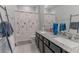Bathroom boasts double sinks, granite countertops, and a tub at 10415 Austrina Oak Loop, Winter Garden, FL 34787