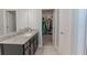 Bathroom with granite countertop and access to closet at 10415 Austrina Oak Loop, Winter Garden, FL 34787
