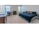 Spacious Primary bedroom with a king-size bed and workspace at 10415 Austrina Oak Loop, Winter Garden, FL 34787