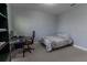 Cozy bedroom featuring a bed, desk, and window at 10415 Austrina Oak Loop, Winter Garden, FL 34787