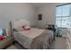 Well-lit bedroom with a queen-size bed and workspace at 10415 Austrina Oak Loop, Winter Garden, FL 34787