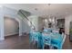 Open concept dining area with teal table and chairs, hardwood floors, and kitchen views at 10415 Austrina Oak Loop, Winter Garden, FL 34787