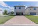 Charming two-story home with a brick driveway and landscaping at 10415 Austrina Oak Loop, Winter Garden, FL 34787