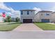 Two-story house with attached garage and well-maintained landscaping at 10415 Austrina Oak Loop, Winter Garden, FL 34787