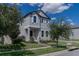 Two-story house with gray siding, white trim, and a landscaped front yard at 10415 Austrina Oak Loop, Winter Garden, FL 34787