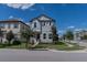 Two-story house with gray siding, white trim, and a landscaped front yard at 10415 Austrina Oak Loop, Winter Garden, FL 34787