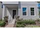 House entrance with dark brown door, white railings, and well-maintained landscaping at 10415 Austrina Oak Loop, Winter Garden, FL 34787