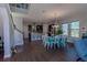 Open floor plan with kitchen island, dining table, and living area at 10415 Austrina Oak Loop, Winter Garden, FL 34787