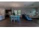Open floor plan with kitchen island, dining table, and living area at 10415 Austrina Oak Loop, Winter Garden, FL 34787