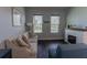 Comfortable living room with a fireplace, neutral-toned sofa, and hardwood floors at 10415 Austrina Oak Loop, Winter Garden, FL 34787