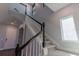 Modern staircase with dark wood railings and carpeted steps at 10415 Austrina Oak Loop, Winter Garden, FL 34787