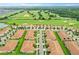 Community overview with numerous houses and a golf course in the background at 1066 Quaker Ridge Ln, Davenport, FL 33896