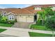 Two-story home with tile roof and a paved driveway at 1066 Quaker Ridge Ln, Davenport, FL 33896