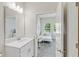 Clean bathroom with single vanity and view into bedroom at 1066 Quaker Ridge Ln, Davenport, FL 33896