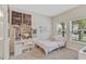 Bedroom with twin bed, workspace, and large windows at 1066 Quaker Ridge Ln, Davenport, FL 33896