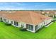 Rear view of the house showcasing a tiled roof and a screened patio at 1066 Quaker Ridge Ln, Davenport, FL 33896