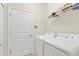Laundry room with washer, dryer, and shelving at 1066 Quaker Ridge Ln, Davenport, FL 33896
