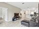 Open living area with a leather sectional and a large TV at 1066 Quaker Ridge Ln, Davenport, FL 33896