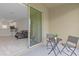 Small patio with table and chairs, view into living area at 1066 Quaker Ridge Ln, Davenport, FL 33896