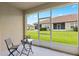 Screened patio with small table and chairs overlooking yard at 1066 Quaker Ridge Ln, Davenport, FL 33896