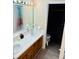 Bathroom with double vanity and a separate toilet area at 1504 Hummingbird Ln, Lakeland, FL 33801