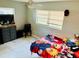 Bedroom with anime bedding and gray dresser at 1504 Hummingbird Ln, Lakeland, FL 33801