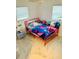 Bedroom with pink metal bed frame and colorful bedding at 1504 Hummingbird Ln, Lakeland, FL 33801