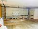 Unfinished garage with large overhead door and storage space at 1504 Hummingbird Ln, Lakeland, FL 33801