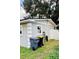 Gray house side with a window, trash cans, and a fence at 1504 Hummingbird Ln, Lakeland, FL 33801