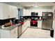 Modern white kitchen with granite countertops and stainless steel appliances at 1504 Hummingbird Ln, Lakeland, FL 33801