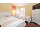 Two twin beds in a bright bedroom with white furniture at 160 Hideaway Beach Ln, Kissimmee, FL 34746
