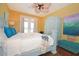 Main bedroom with light blue bed frame, balcony access, and artwork at 160 Hideaway Beach Ln, Kissimmee, FL 34746