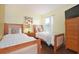 Bedroom with twin beds, light wood frames, and dresser at 160 Hideaway Beach Ln, Kissimmee, FL 34746