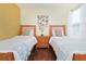 Two twin beds with wood frame, nightstand, and artwork at 160 Hideaway Beach Ln, Kissimmee, FL 34746