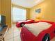 Bedroom with two red car beds and a TV at 160 Hideaway Beach Ln, Kissimmee, FL 34746