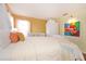 Bedroom with white ornate bed frame and colorful artwork at 160 Hideaway Beach Ln, Kissimmee, FL 34746
