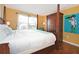 King-size bed with wooden frame and artwork at 160 Hideaway Beach Ln, Kissimmee, FL 34746