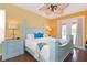 Main bedroom with light blue bed frame, and access to a balcony at 160 Hideaway Beach Ln, Kissimmee, FL 34746