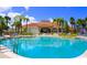 Resort-style pool with surrounding lounge chairs and palm trees at 160 Hideaway Beach Ln, Kissimmee, FL 34746