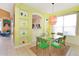 Charming dining room with a glass table, green chairs, and built-in shelving at 160 Hideaway Beach Ln, Kissimmee, FL 34746