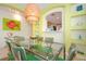 Dining area with glass table, green chairs, and a unique light fixture at 160 Hideaway Beach Ln, Kissimmee, FL 34746