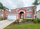 Two-story house with a large garage and well-manicured landscaping at 160 Hideaway Beach Ln, Kissimmee, FL 34746