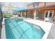 Relaxing screened pool with patio furniture and lake view at 160 Hideaway Beach Ln, Kissimmee, FL 34746