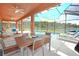Pool area with patio table and chairs, and lake view at 160 Hideaway Beach Ln, Kissimmee, FL 34746
