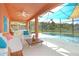 Relaxing pool area with patio furniture, shade sail, and lake view at 160 Hideaway Beach Ln, Kissimmee, FL 34746