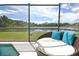 Relaxing circular daybed near pool and lake view at 160 Hideaway Beach Ln, Kissimmee, FL 34746