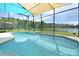 Inviting swimming pool with screened enclosure and lake view at 160 Hideaway Beach Ln, Kissimmee, FL 34746