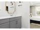 Modern bathroom with gray vanity and a view of a bedroom at 1829 Tropical Palms Cir Cir, Kissimmee, FL 34747
