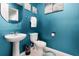 Small bathroom with teal walls and pedestal sink at 1829 Tropical Palms Cir Cir, Kissimmee, FL 34747